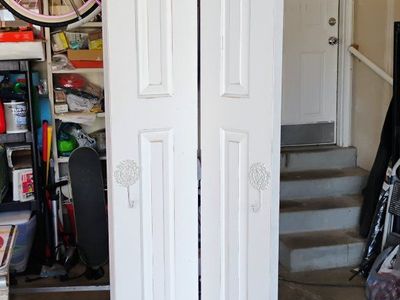 White 2-Panel Interior Bi-Fold Closet Door with Brass Hinges & Decorative Hooks