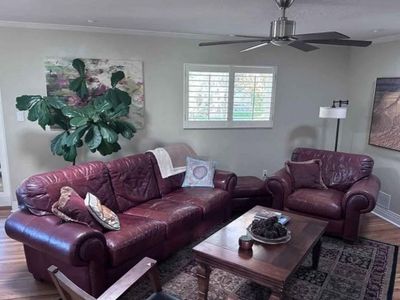 Leather sofa set. coffee table, rug, and painting