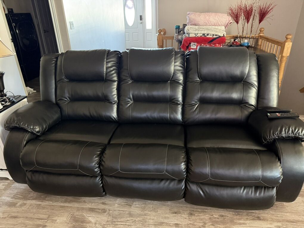 Black Vinyl Couch And Rocking Chairs