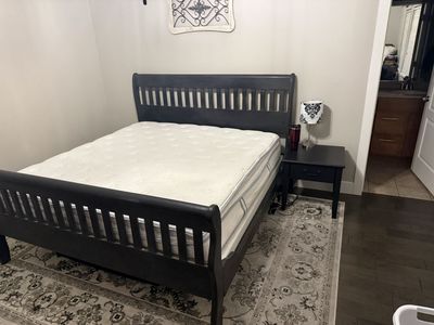 Dark Wood King Sleigh Bed Frame with Slatted Headboard and Footboard - Mattress nightstand and rug included.