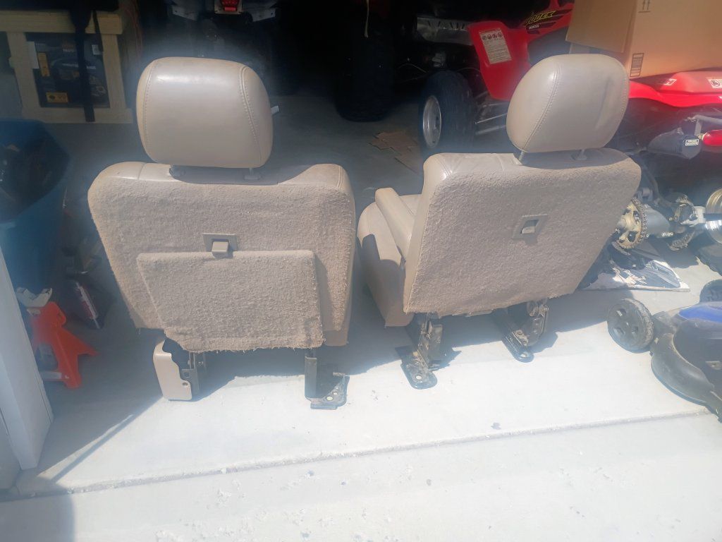 tan early 2000s suburban 2nd row captains chairs