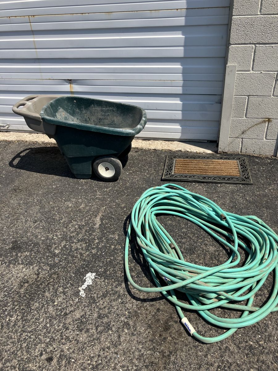 Wheelbarrow, garden hose or door mat