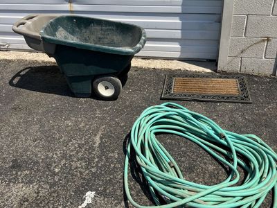 Wheelbarrow, garden hose or door mat