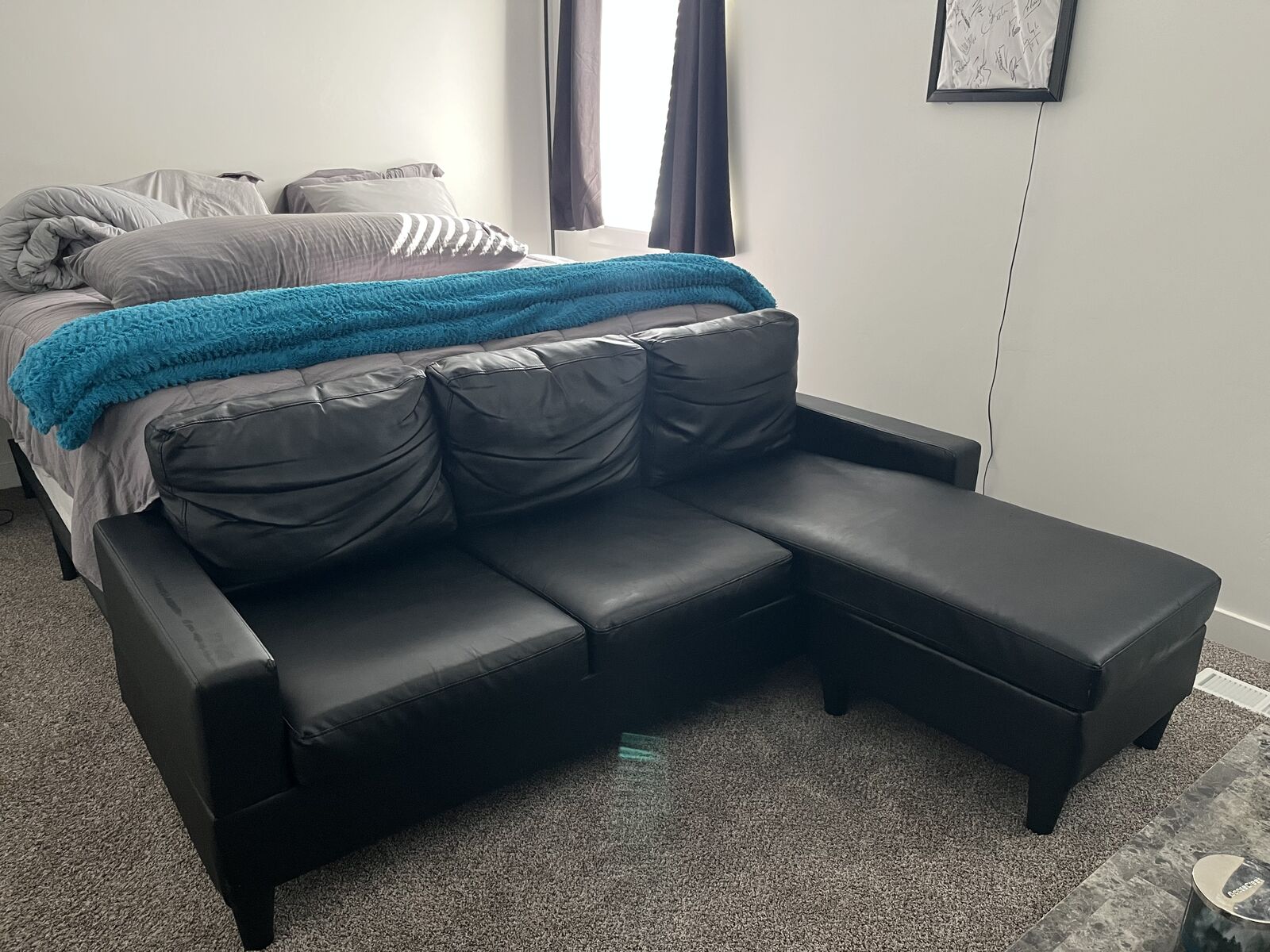Compact, black leather couch