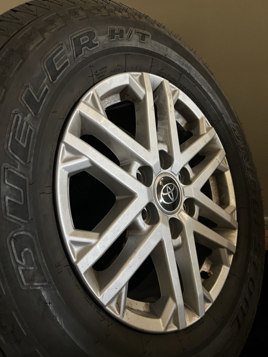 Bridgestone dueler H/T 265/70R18 Tires and Toyota Rims - Excellent Condition. Taken off of a 2023 Toyota tundra sr5