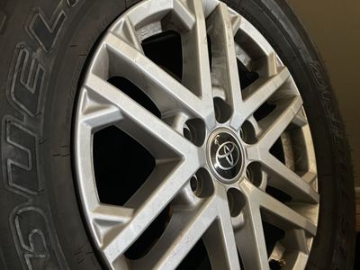 Bridgestone dueler H/T 265/70R18 Tires and Toyota Rims - Excellent Condition. Taken off of a 2023 Toyota tundra sr5