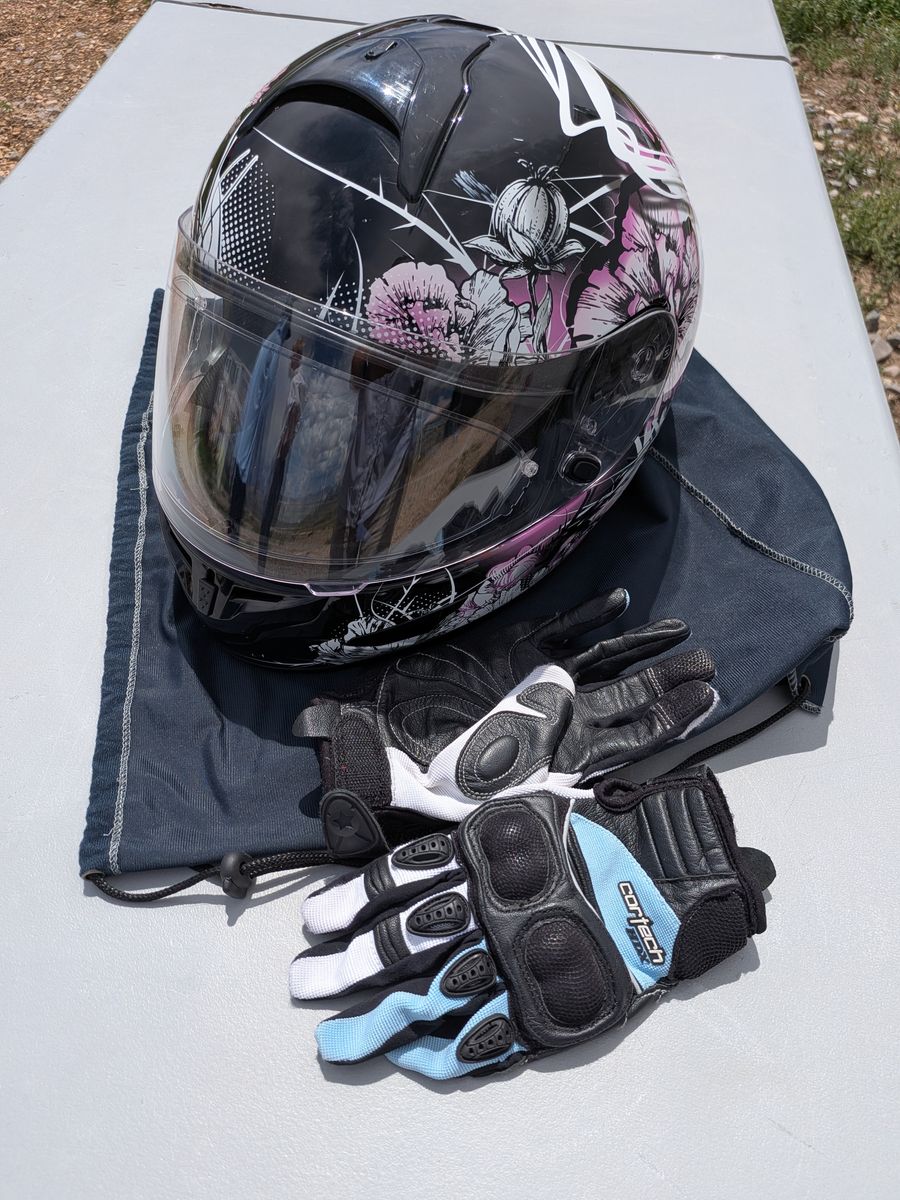 Women's motorcycle helmet size Extra Small and some Medium riding gloves.