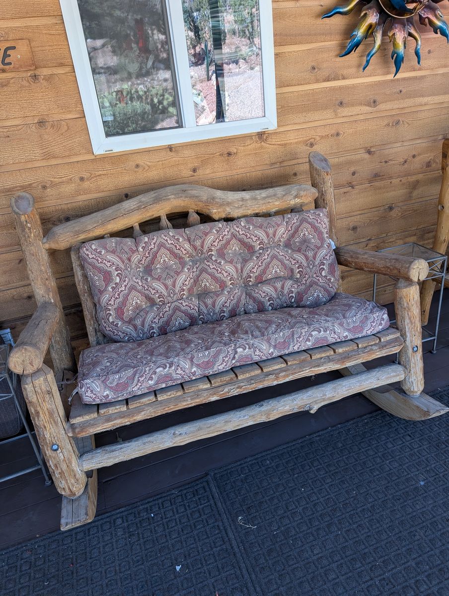 Rustic wooden rocker double seated.