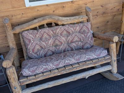 Rustic wooden rocker double seated.