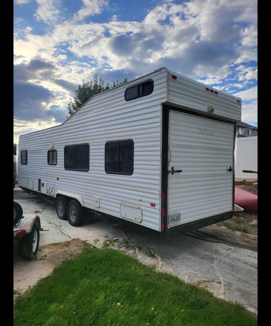 Used Travel Trailer RV Interior with Kitchenette, Bathroom, and Sleeping Area